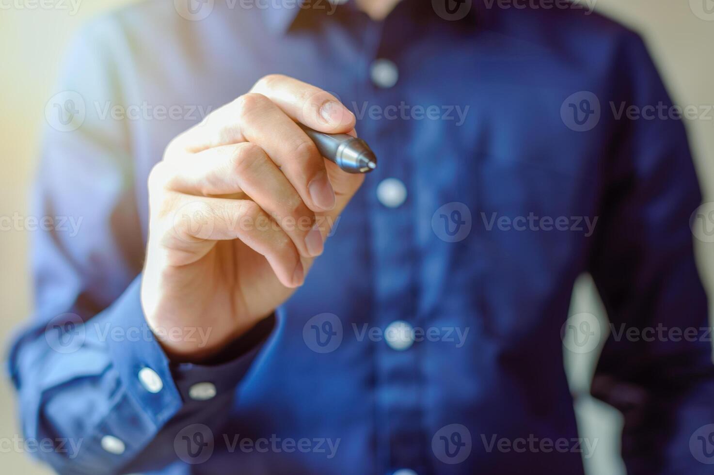 Businessman uses a pen photo