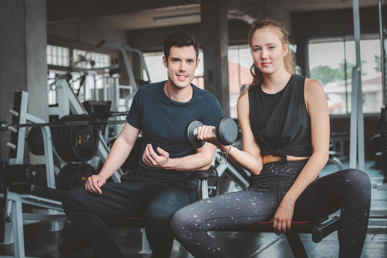 Couple working out together in gym photo