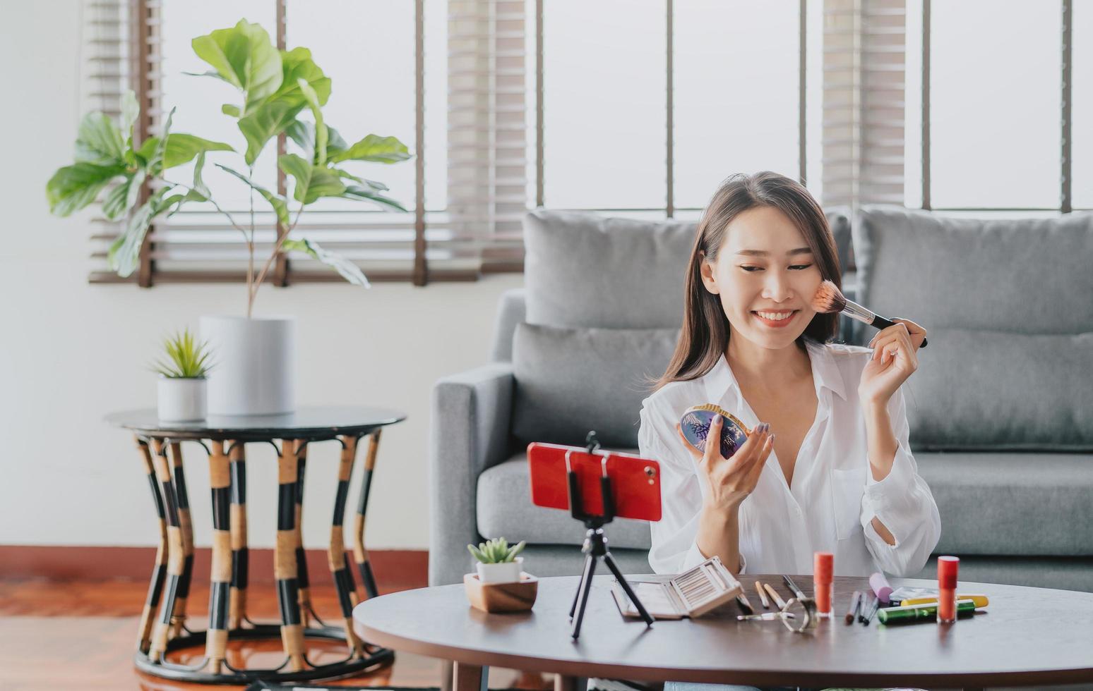 Female blogger recording live stream beauty video photo