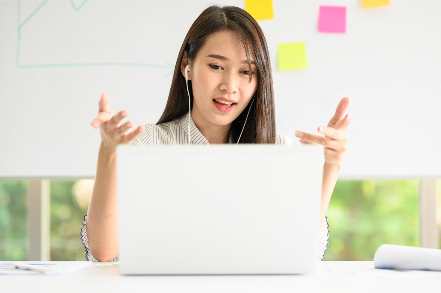 Woman having video meeting conference call via laptop photo