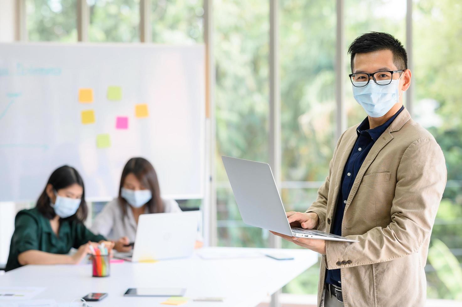 Businessman wears face mask at office photo