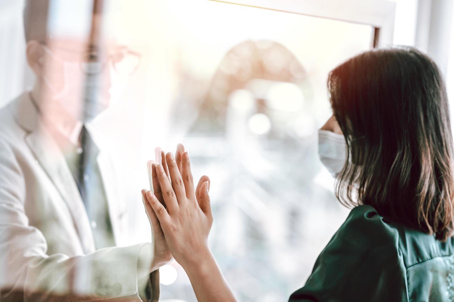 Asian couple wearing face mask separated due to public health concern photo