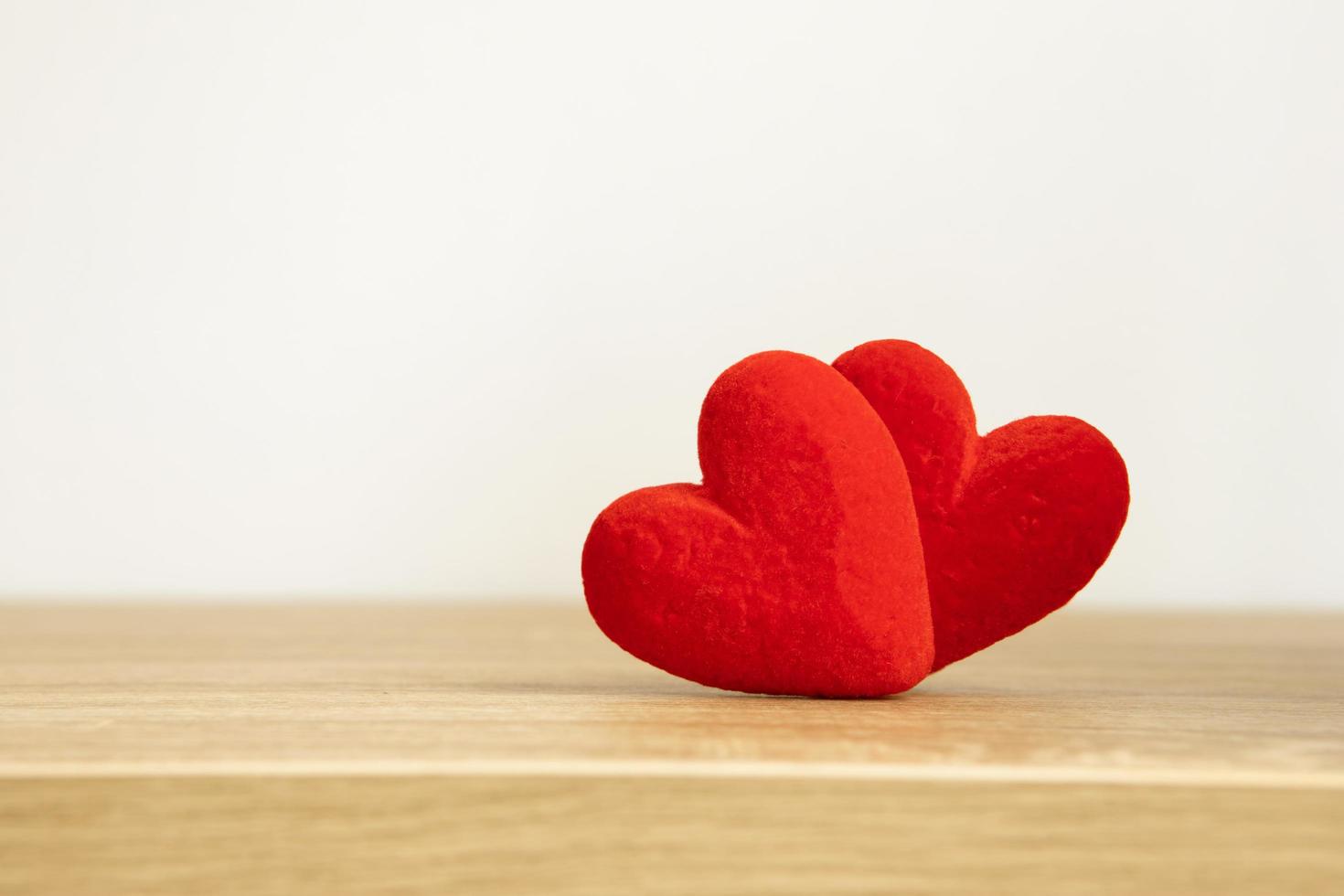 Two red hearts together on white background  photo