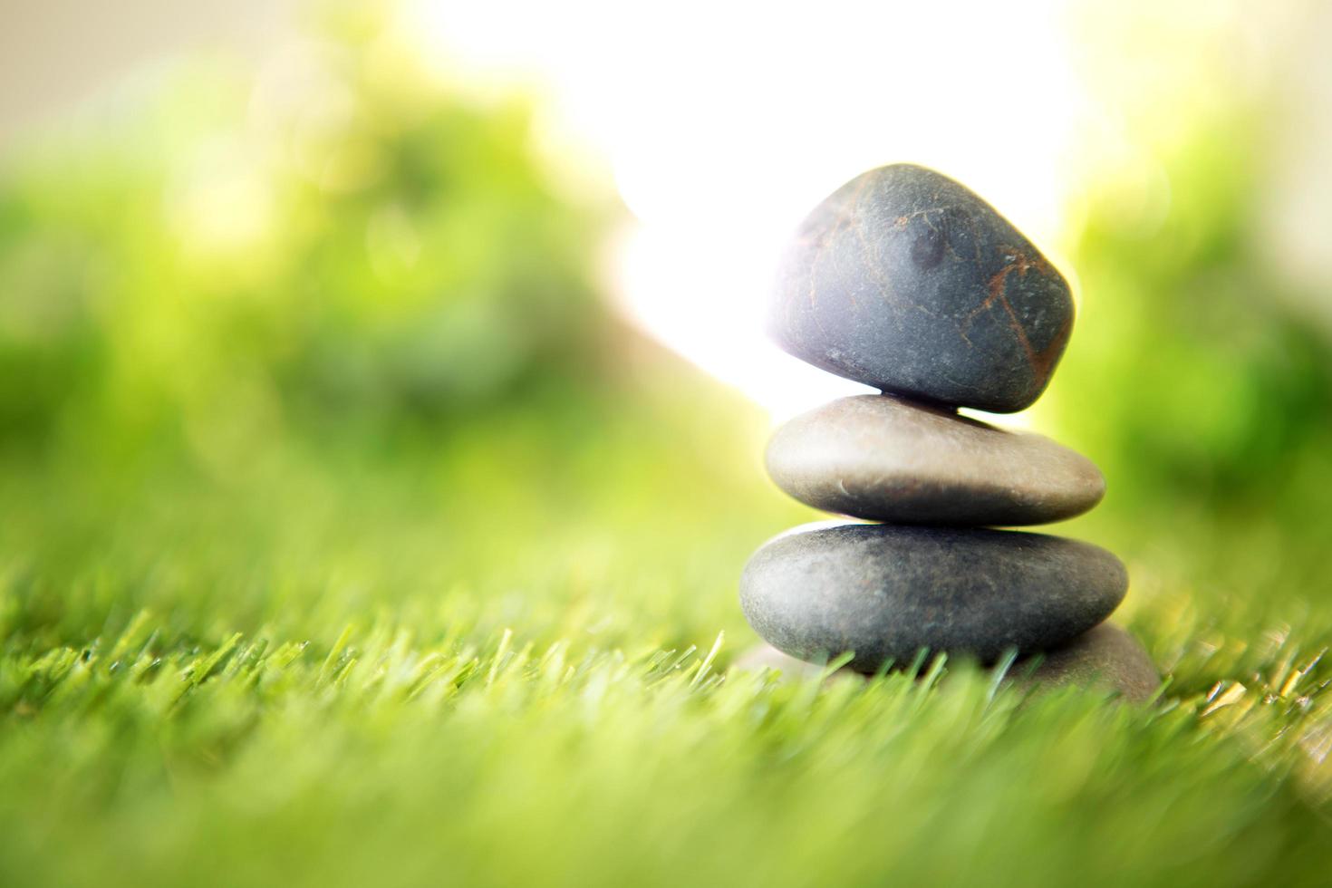 Stone pyramid on grass photo