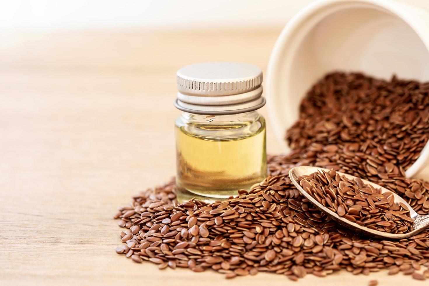 Close-up of flaxseed and flaxseed oil on wooden table photo