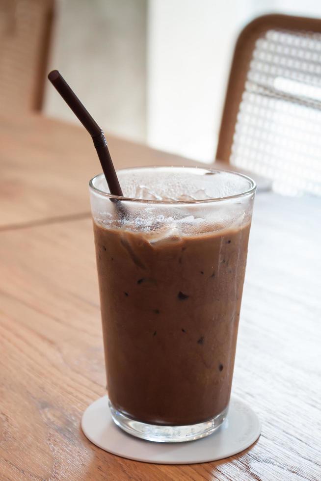 Iced coffee in coffee shop on wooden table photo