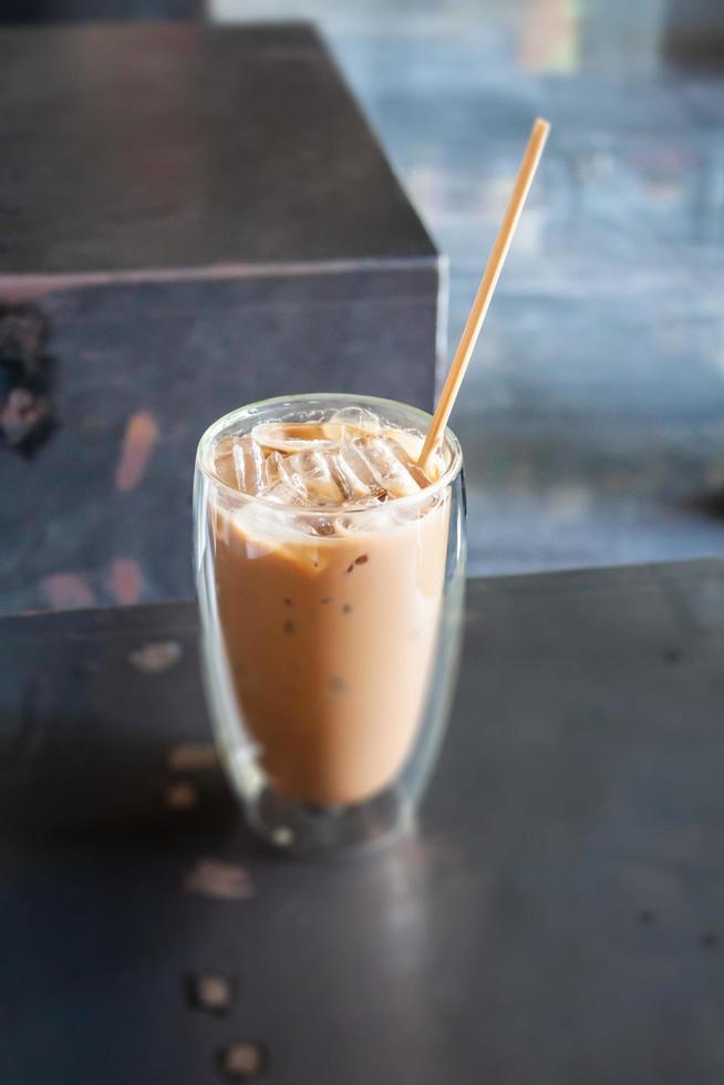 Iced coffee in coffee shop on wooden table photo