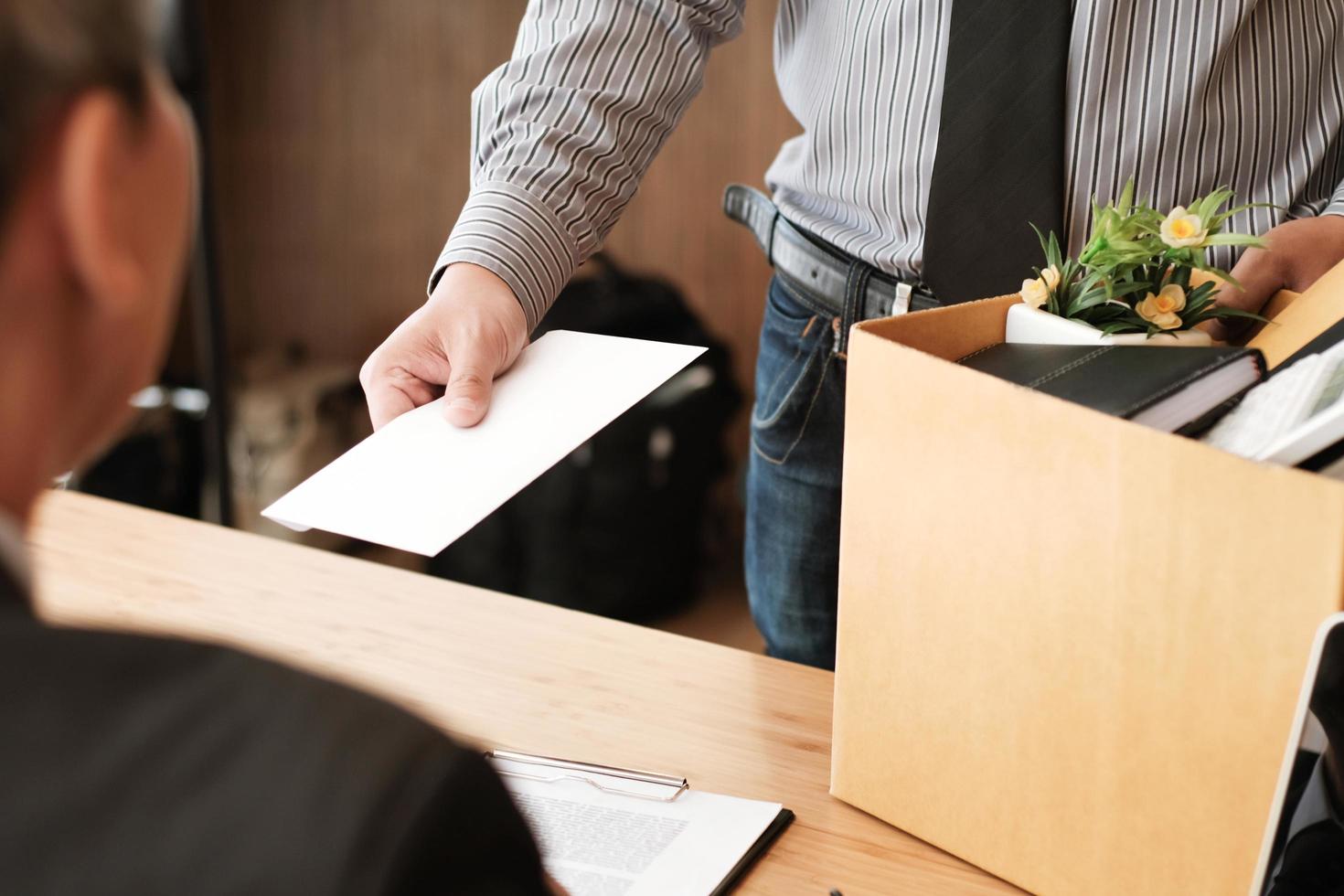 Businessman handing resignation letter to boss photo