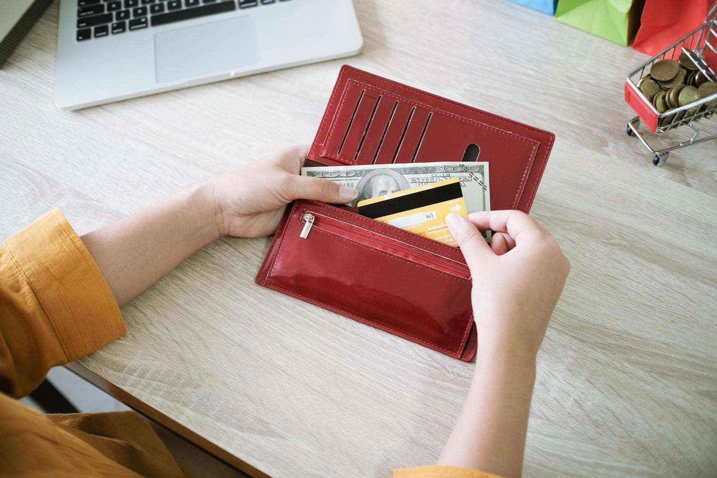 Woman pulling out credit card from wallet photo