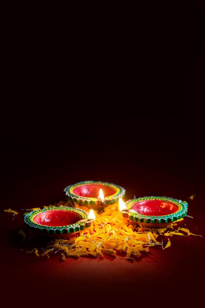 Colorful Diya lamps lit in dark room photo