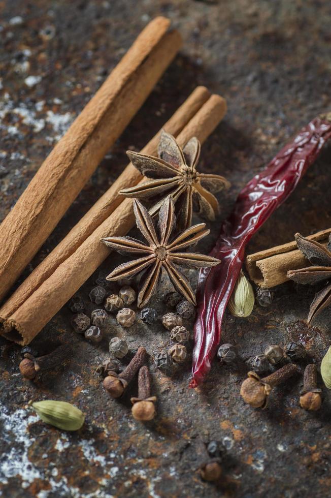 Spices and herbs on textured background photo