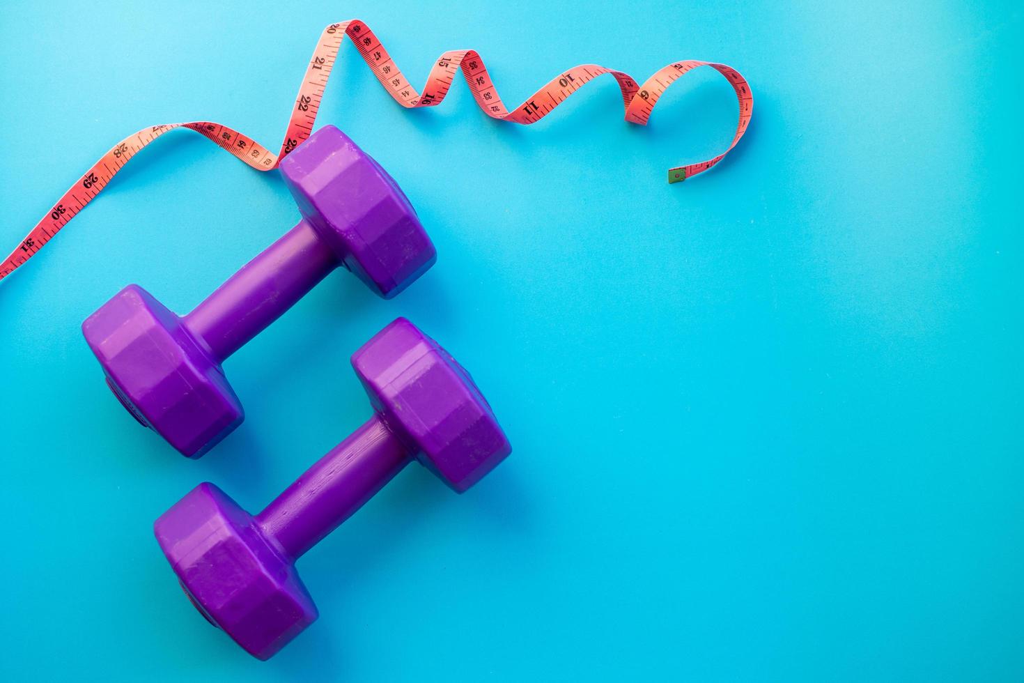 Fitness equipment dumbbells on color background photo