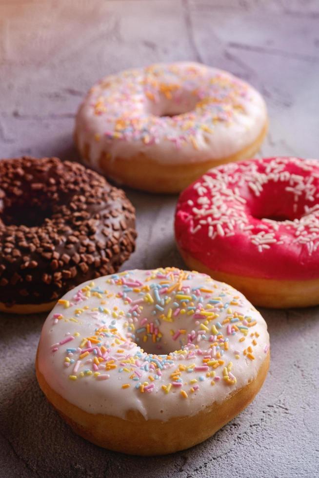 Multi-flavored donuts with sprinkles photo