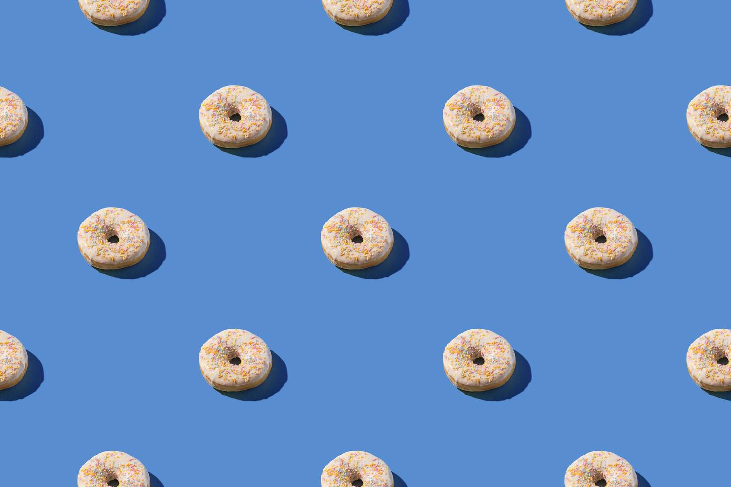 Vanilla white donuts in a  seamless pattern photo