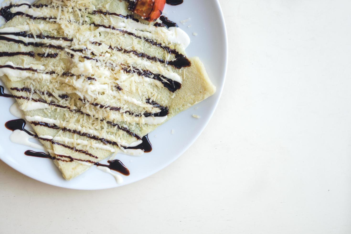 Crepe on white plate, copy space photo