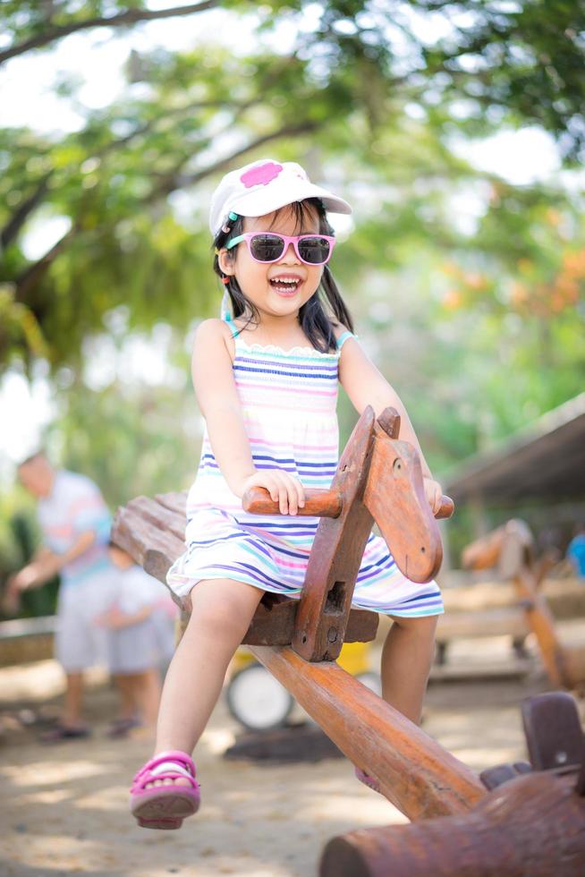 Young Asian girl on seesaw  photo