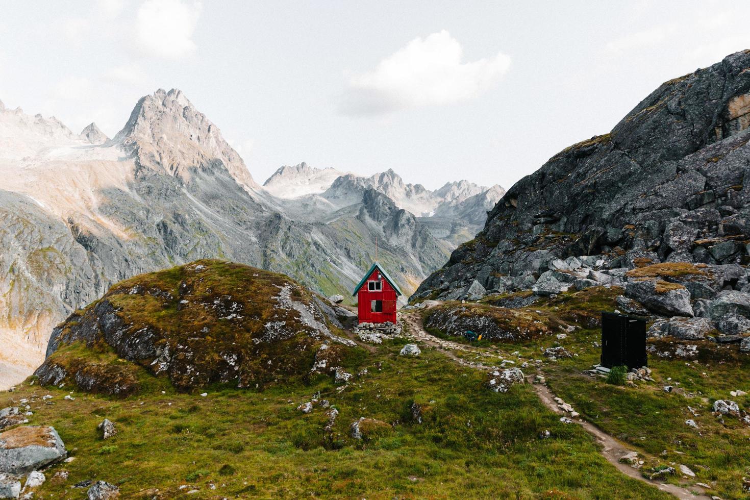 Red cabin in mountains photo