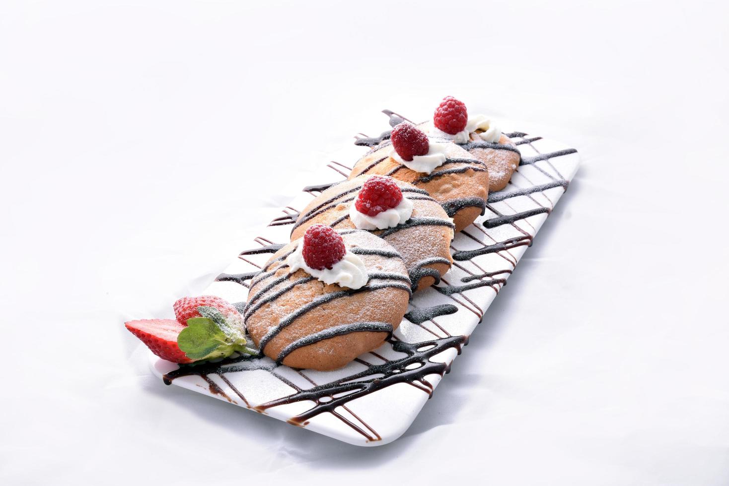Oatmeal cookies with chocolate, raspberry, and strawberry photo