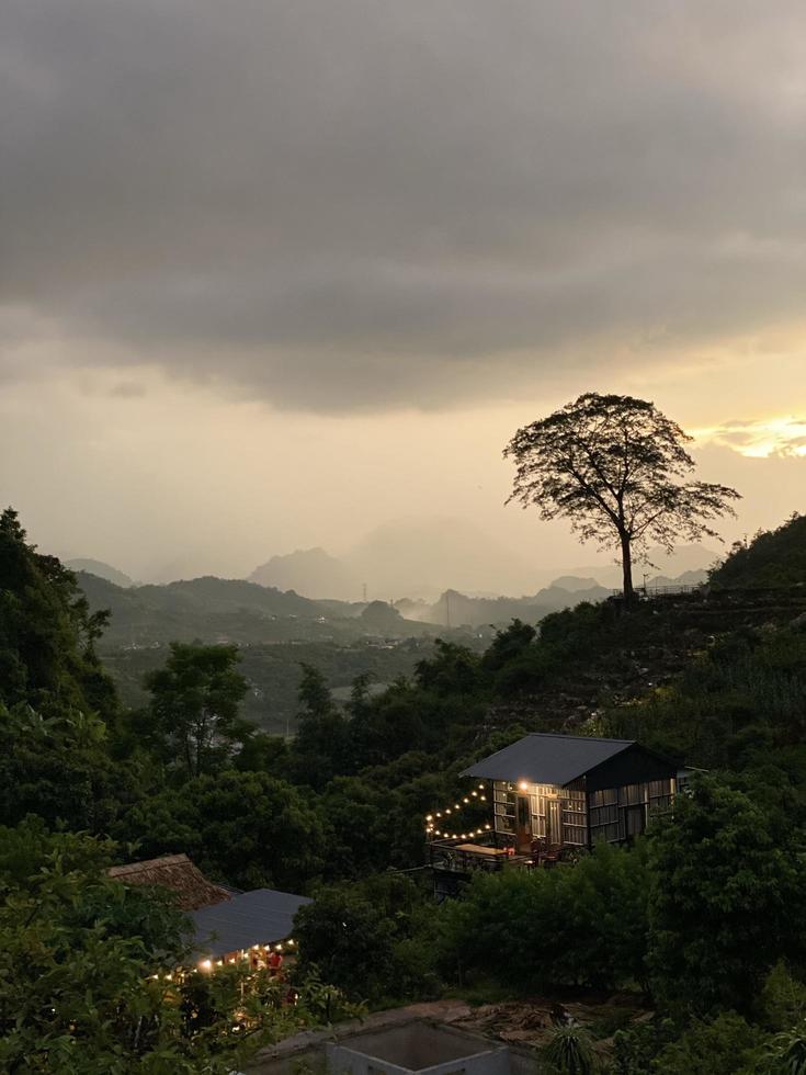 House among trees and mountains photo