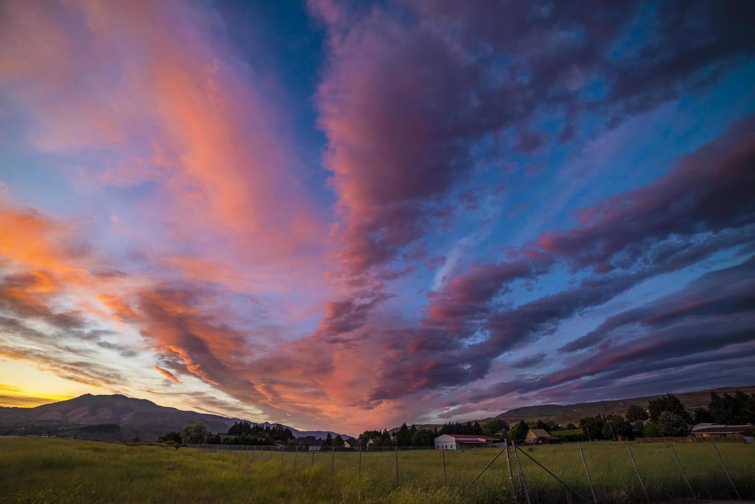 Colorful sunset over field photo