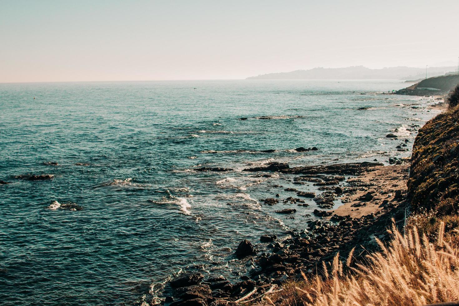 Ocean waves crashing on rocks photo