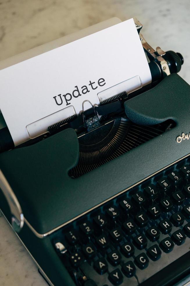 Green typewriter with the word Update typed out photo