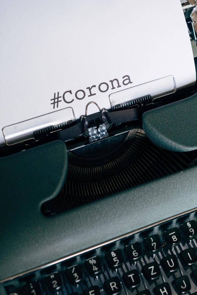 Green typewriter with the word Corona typed out photo