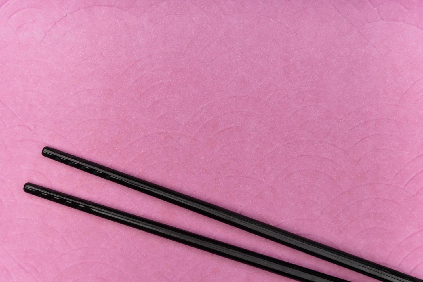 Chopsticks on purple background photo