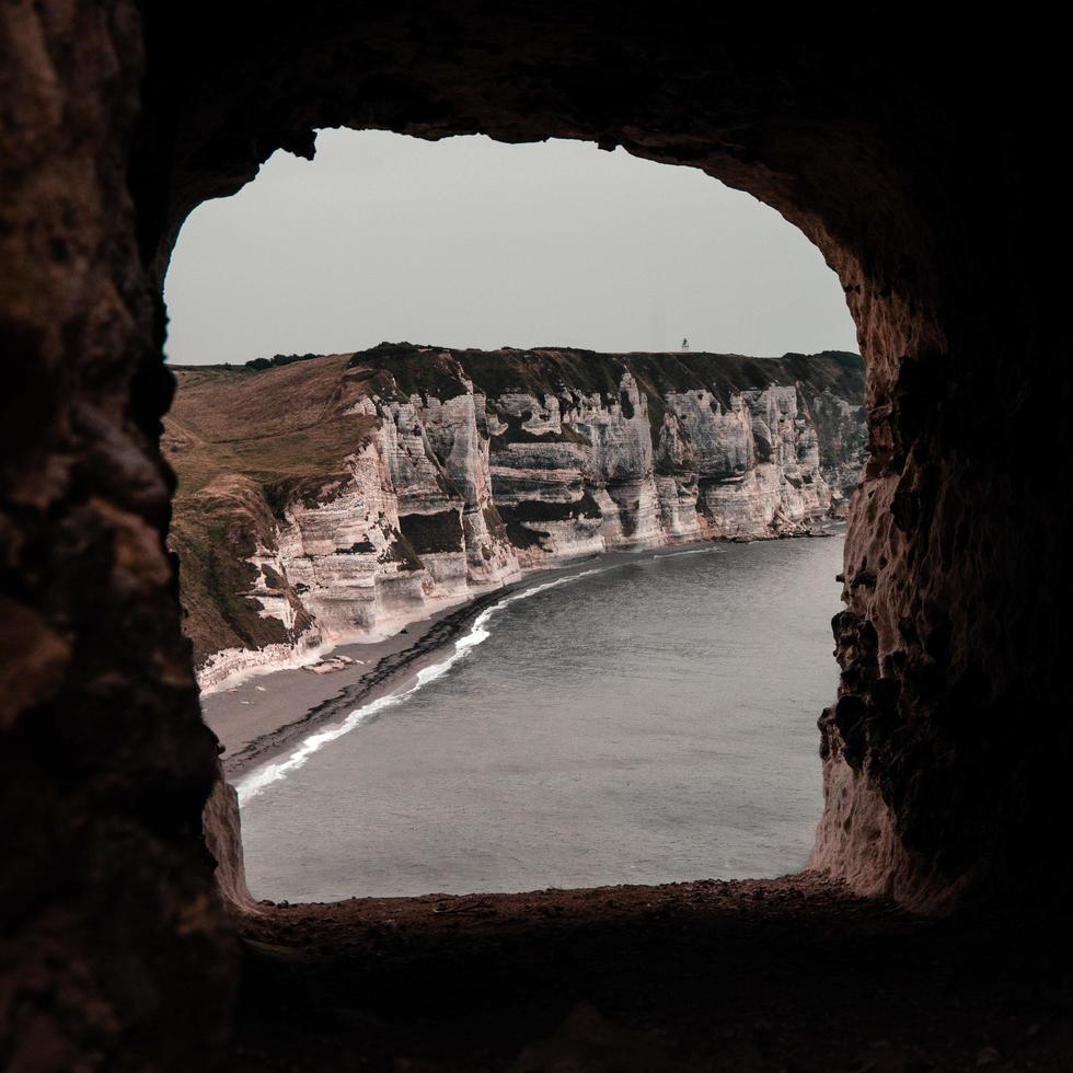 View through cave window to shoreline photo