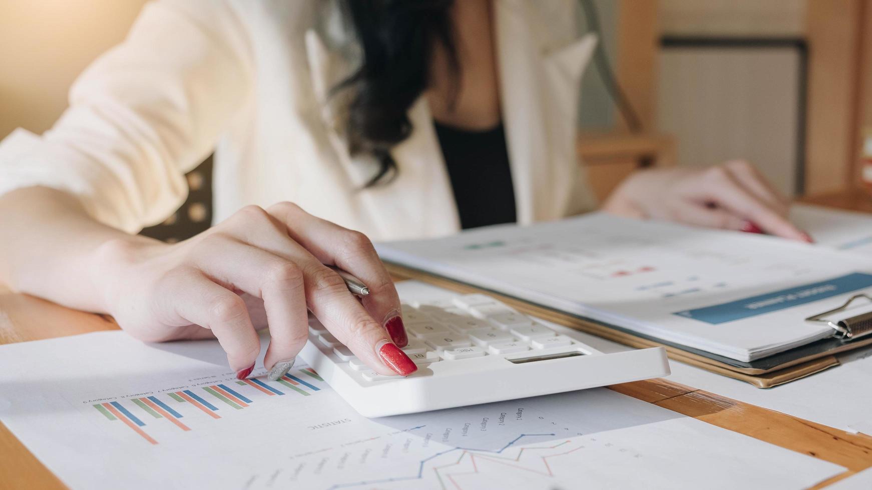 Close-up view of bookkeeper making calculations photo