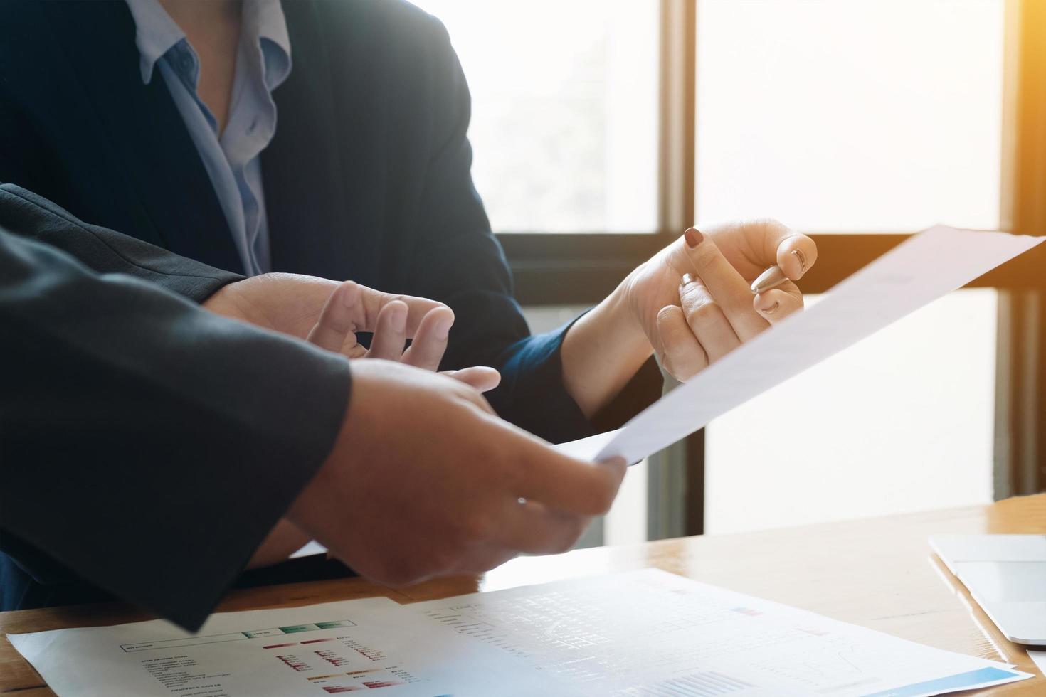 Business people looking over document photo