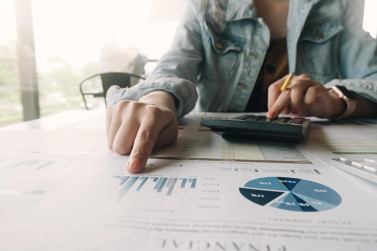 Close-up of woman checking calculations photo