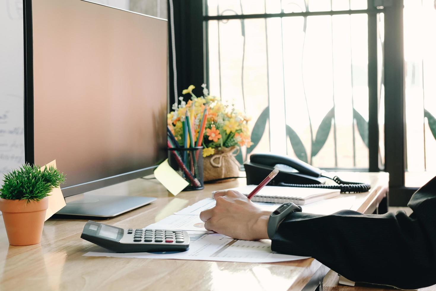 Close-up of professional working at desk photo