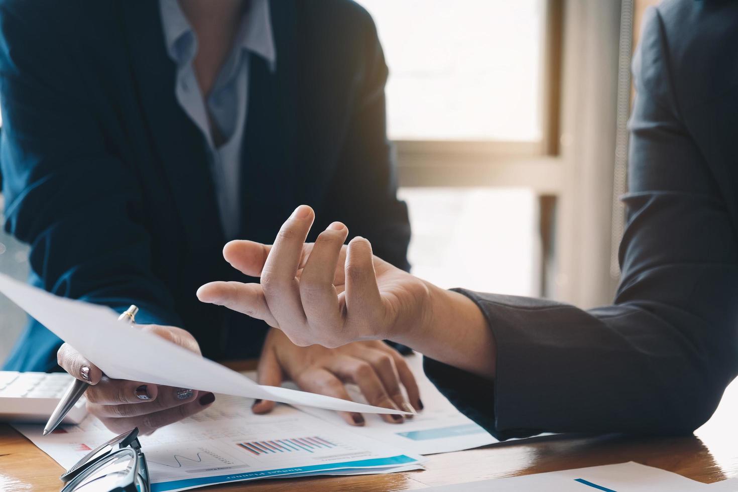 Two business professionals looking at document photo