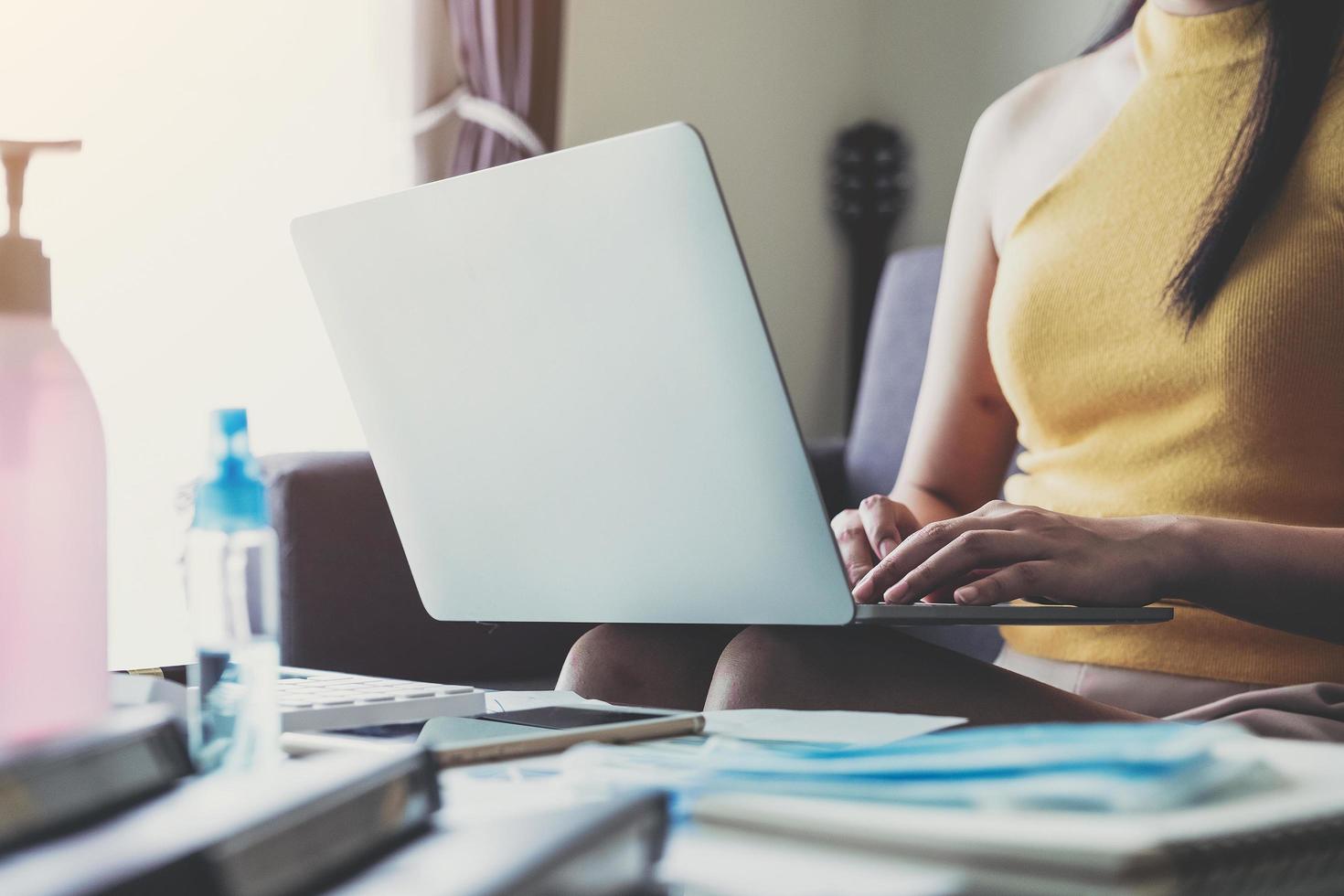 Close-up of woman working remotely from home photo