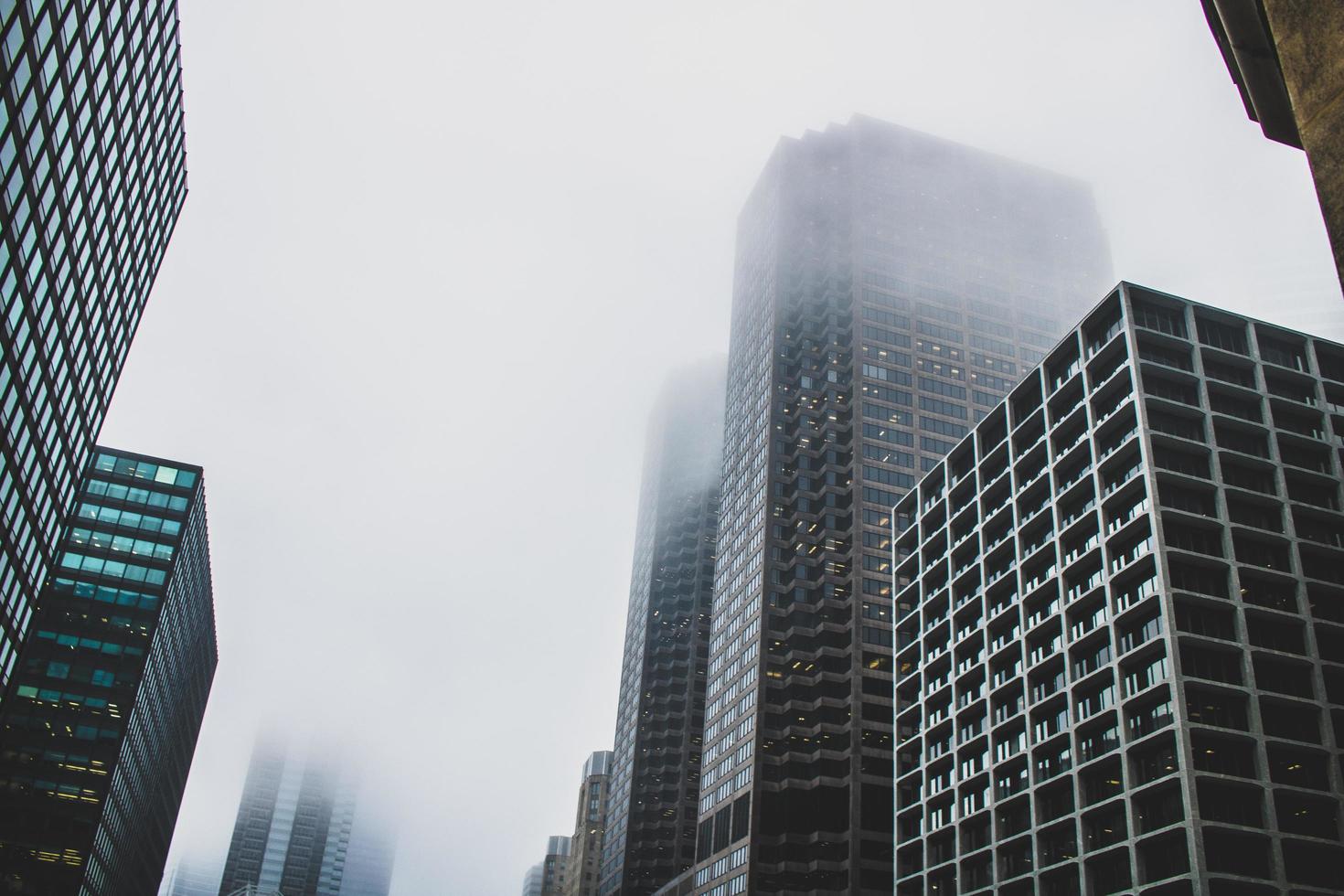 Foggy skyscraper buildings from below photo