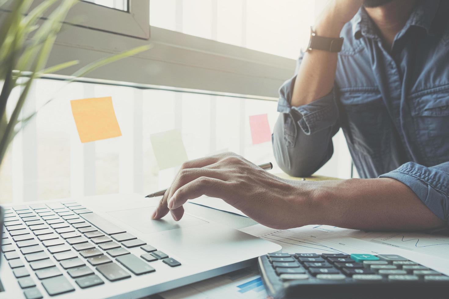 Close-up of businessman working on laptop computer photo