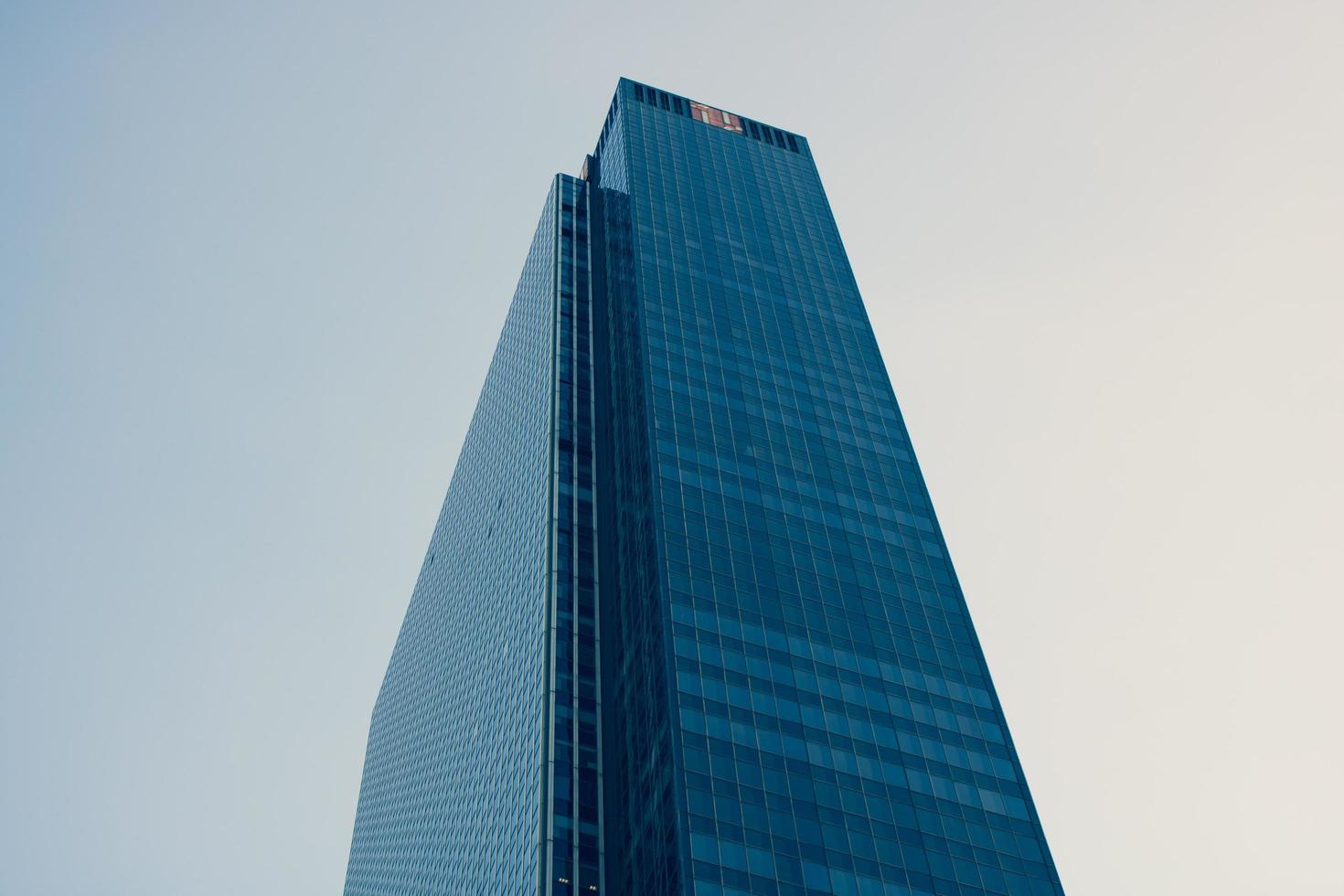 Skyscraper building under cloudy sky photo