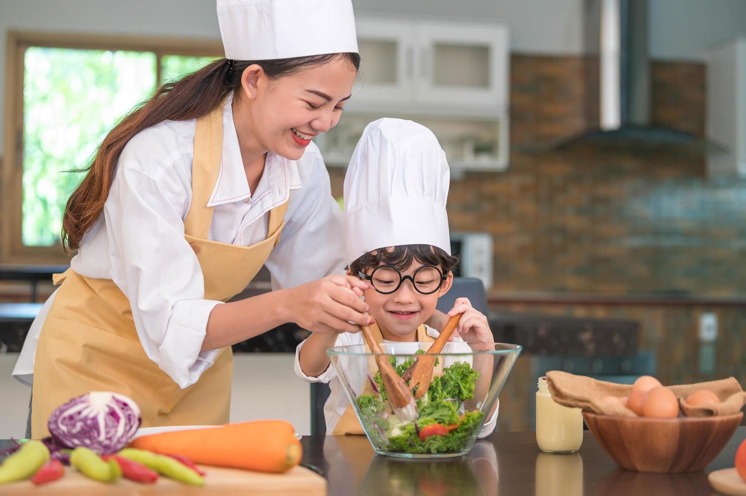 Mother and child prepare a salad together photo