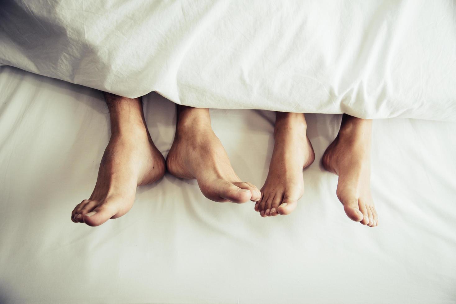 Barefoot couple under a blanket photo