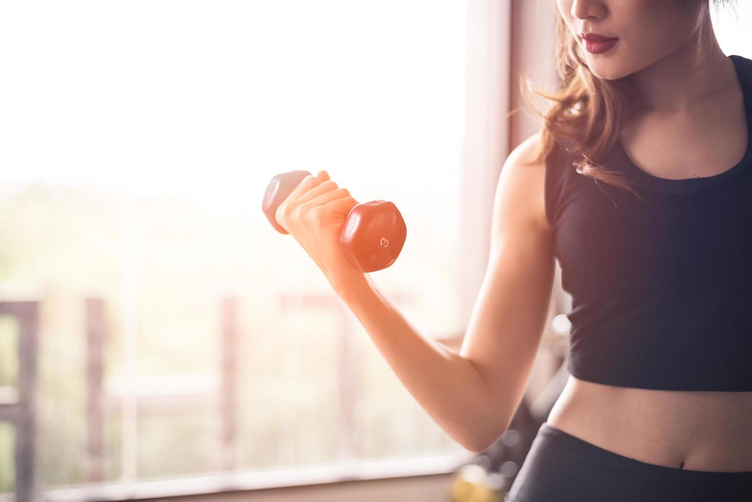 Woman lifts dumbbell  photo
