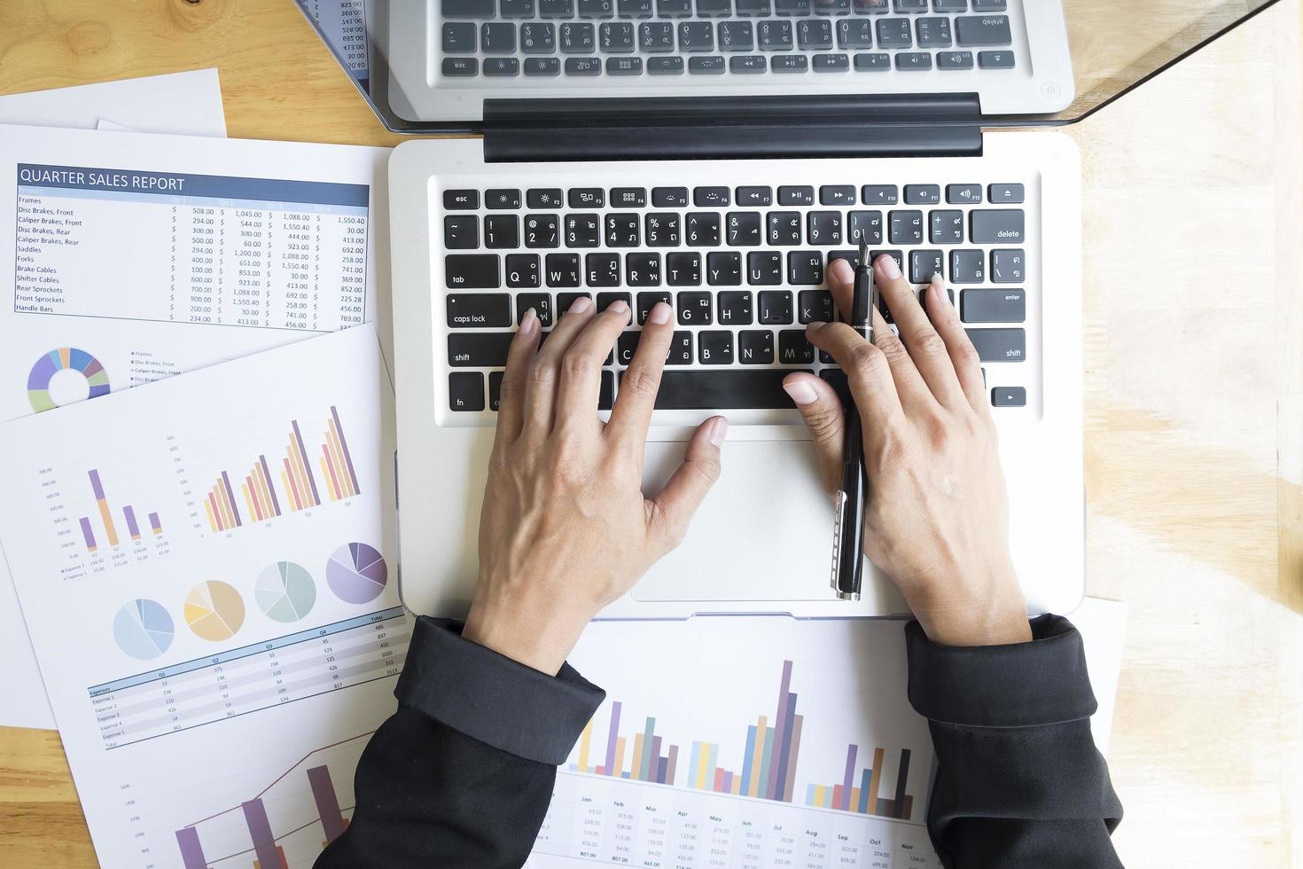 Table top view of businessperson using a laptop at work photo