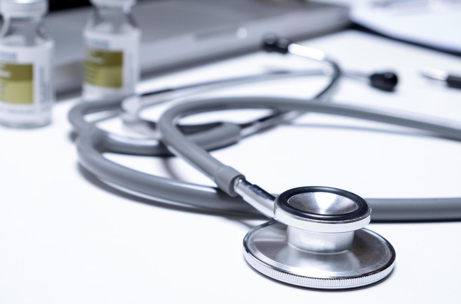 A medical stethoscope sits on table at  hospital photo