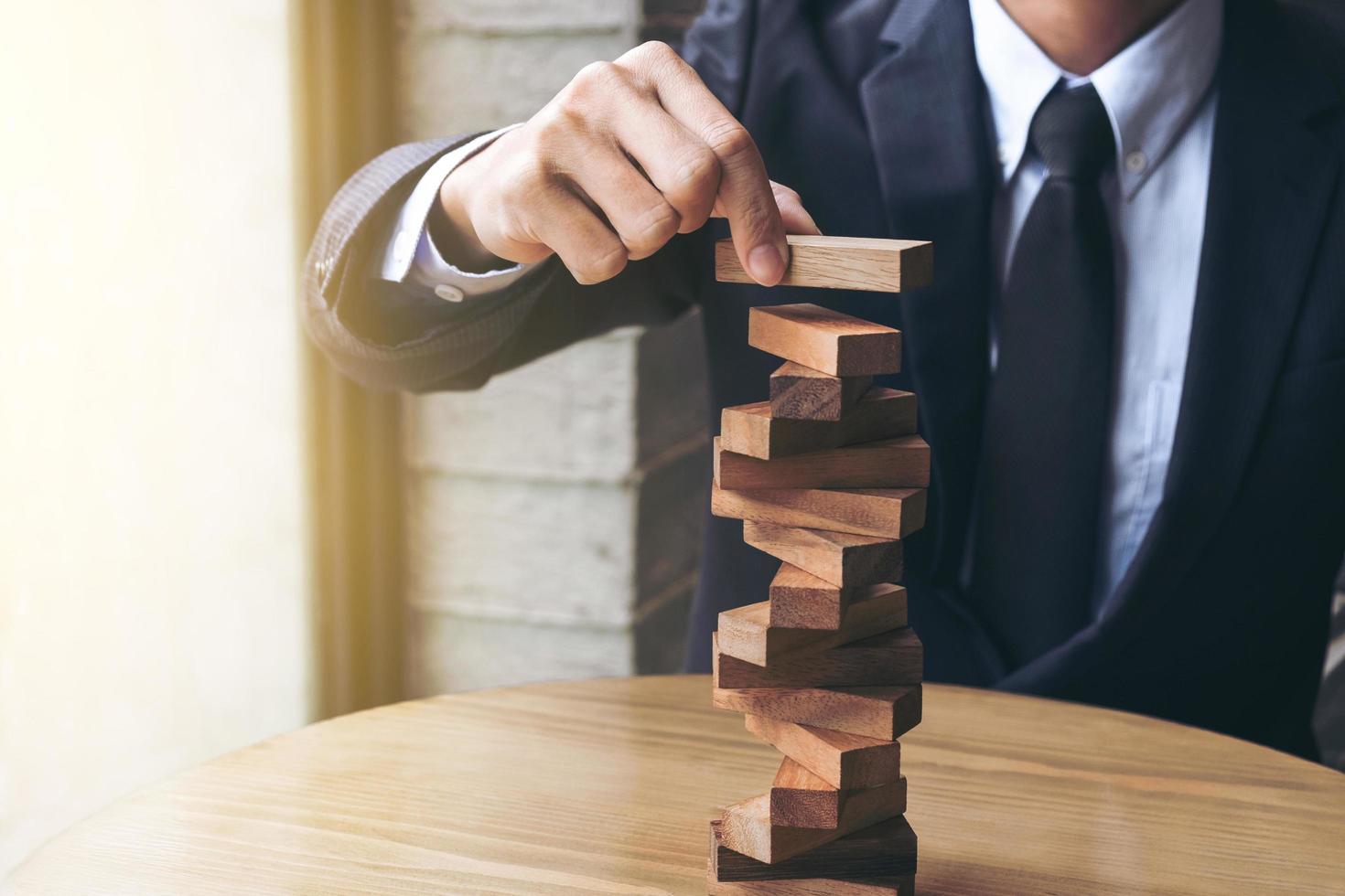 Man building wooden block tower photo