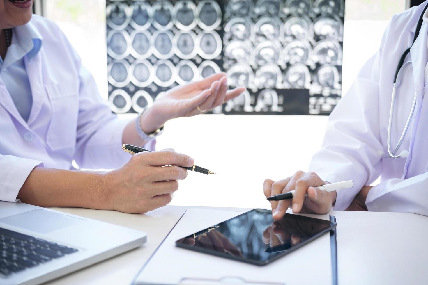 Two medical professionals discussing patient treatment  photo