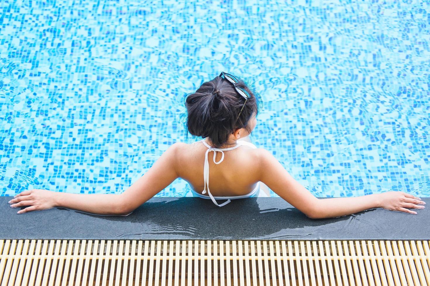 Woman relaxing in swimming pool photo