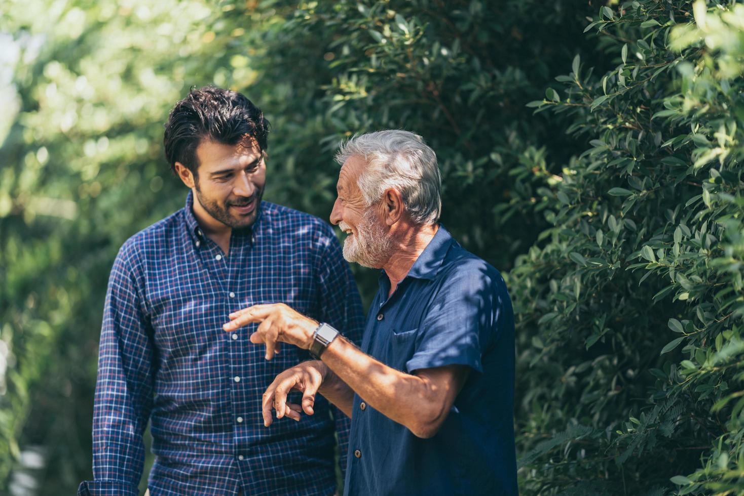 Old father and adult son relax in the backyard photo