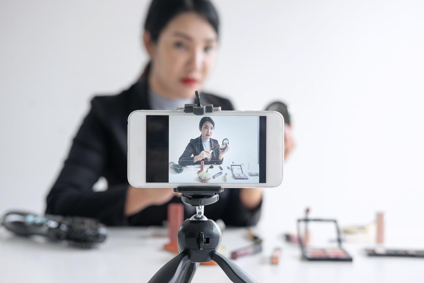 Woman is recording makeup video tutorial  photo