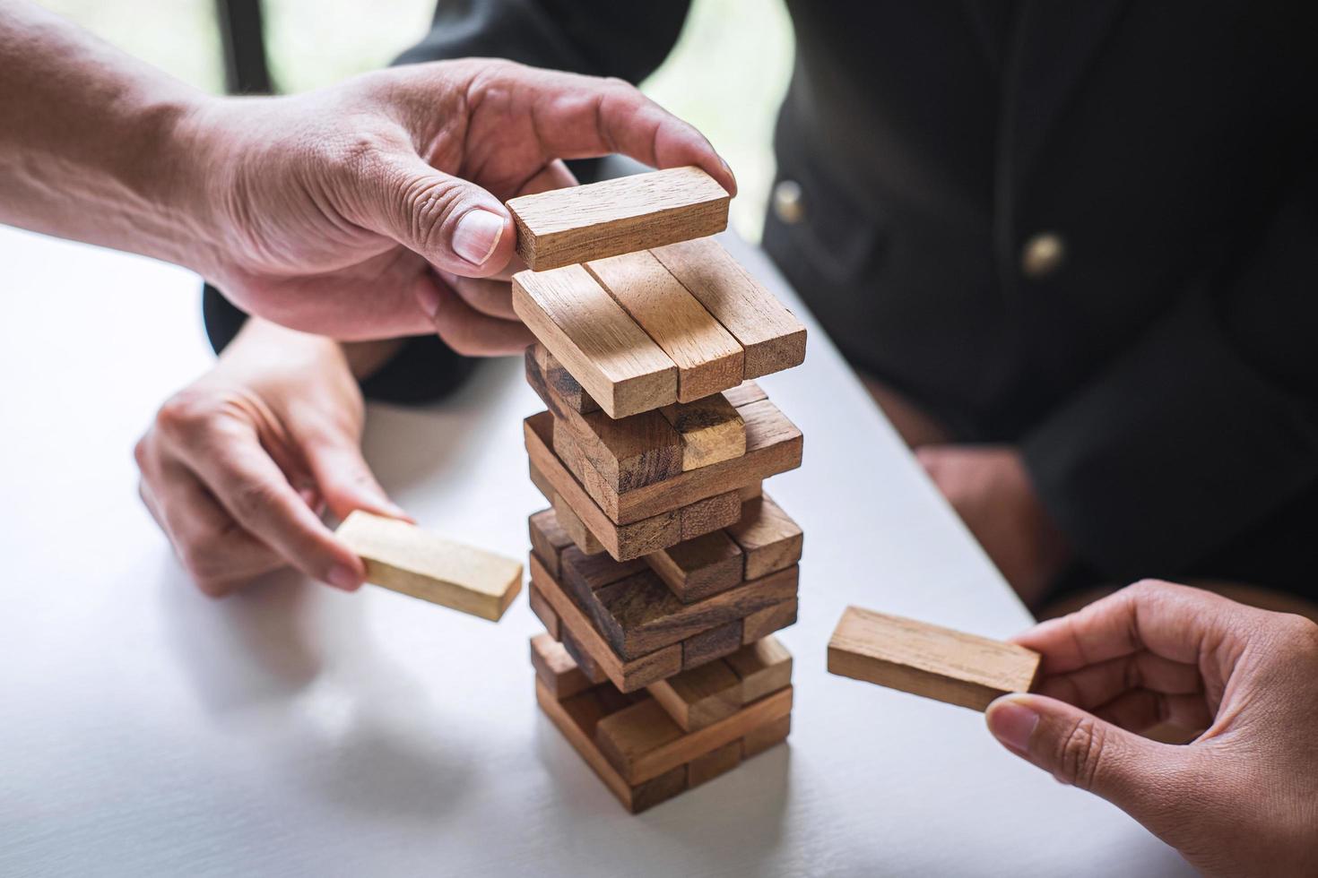 People stacking wooden blocks photo