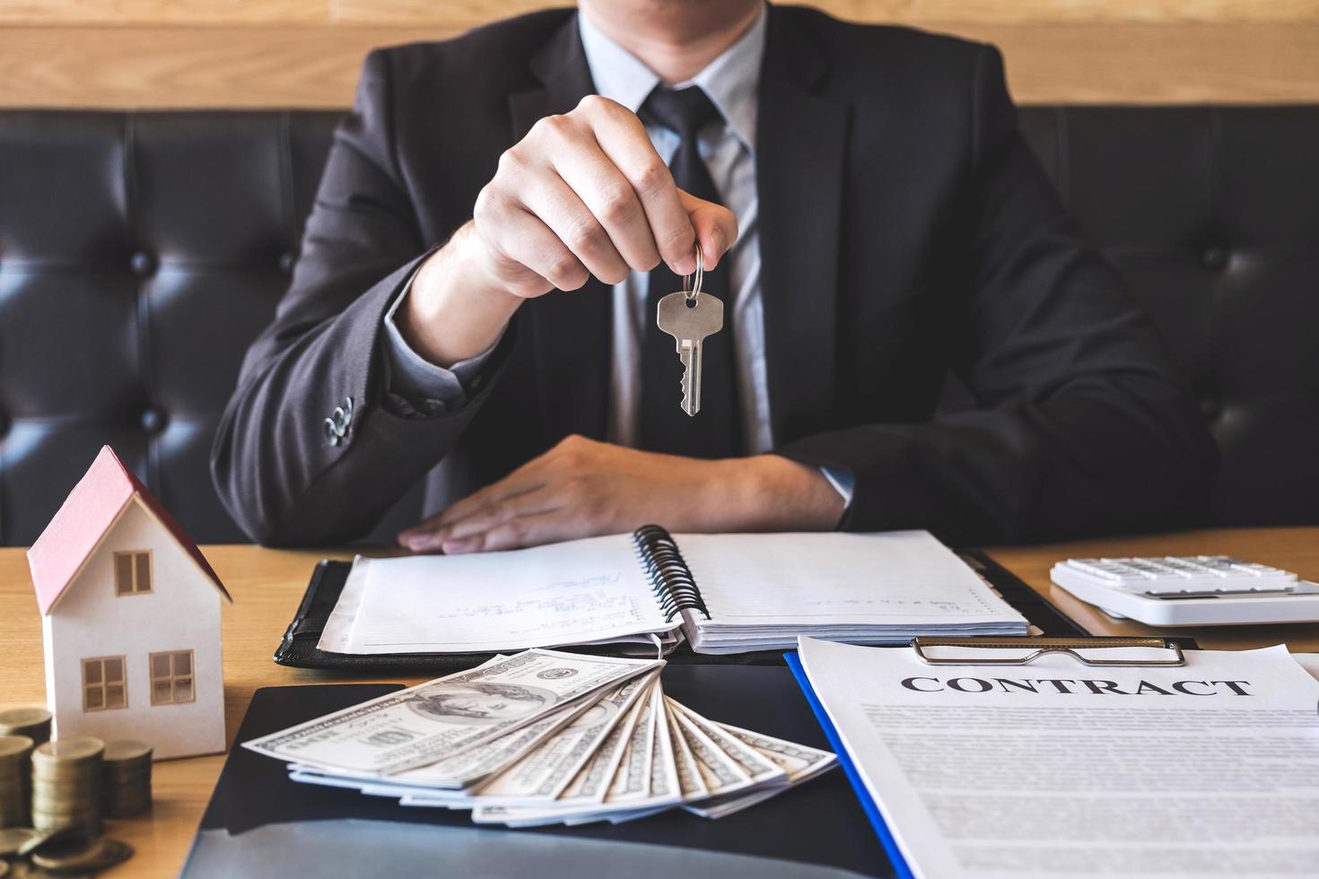 Real estate agent handing over house keys  photo